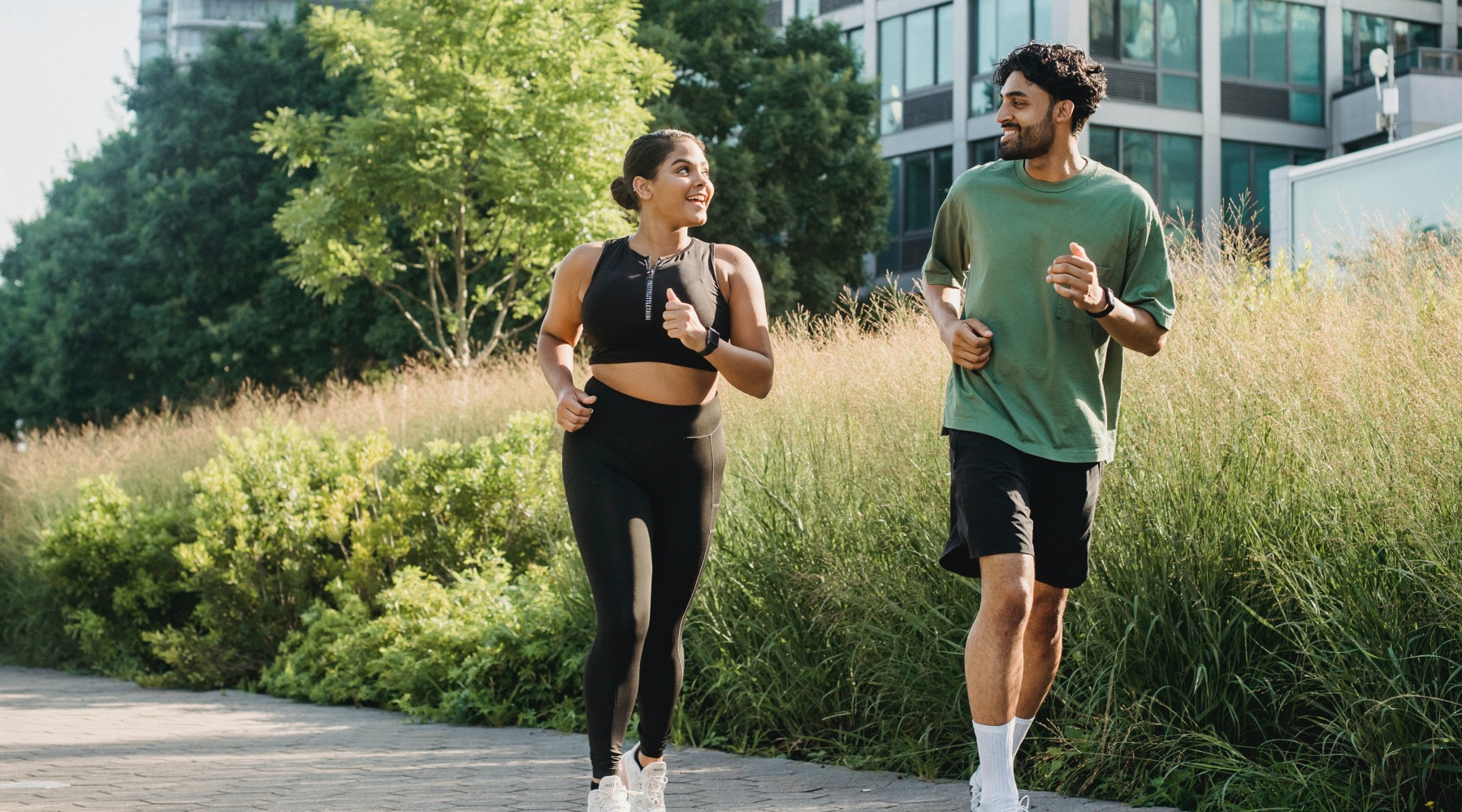 Live Beautifully lifestyle image of a couple of people jogging outdoors